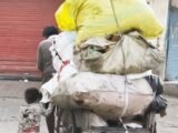 THIS LITTLE GIRL HELPS HER RAG-PICKER FATHER