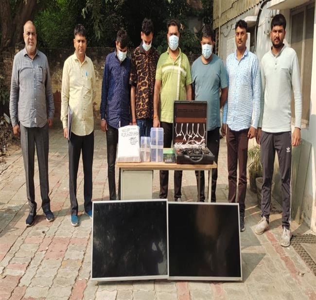 FOUR GAMBLERS BETTING ON CRICKET MATCH BUSTED, CASH AND ELECTROINIC GADGETS RECOVERED